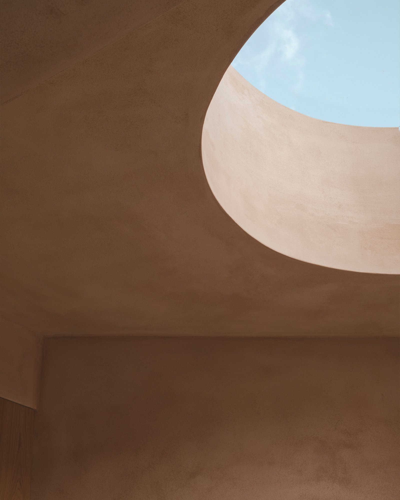 Clay plaster interior with Portland stone facing beyond at Balmore House, London.