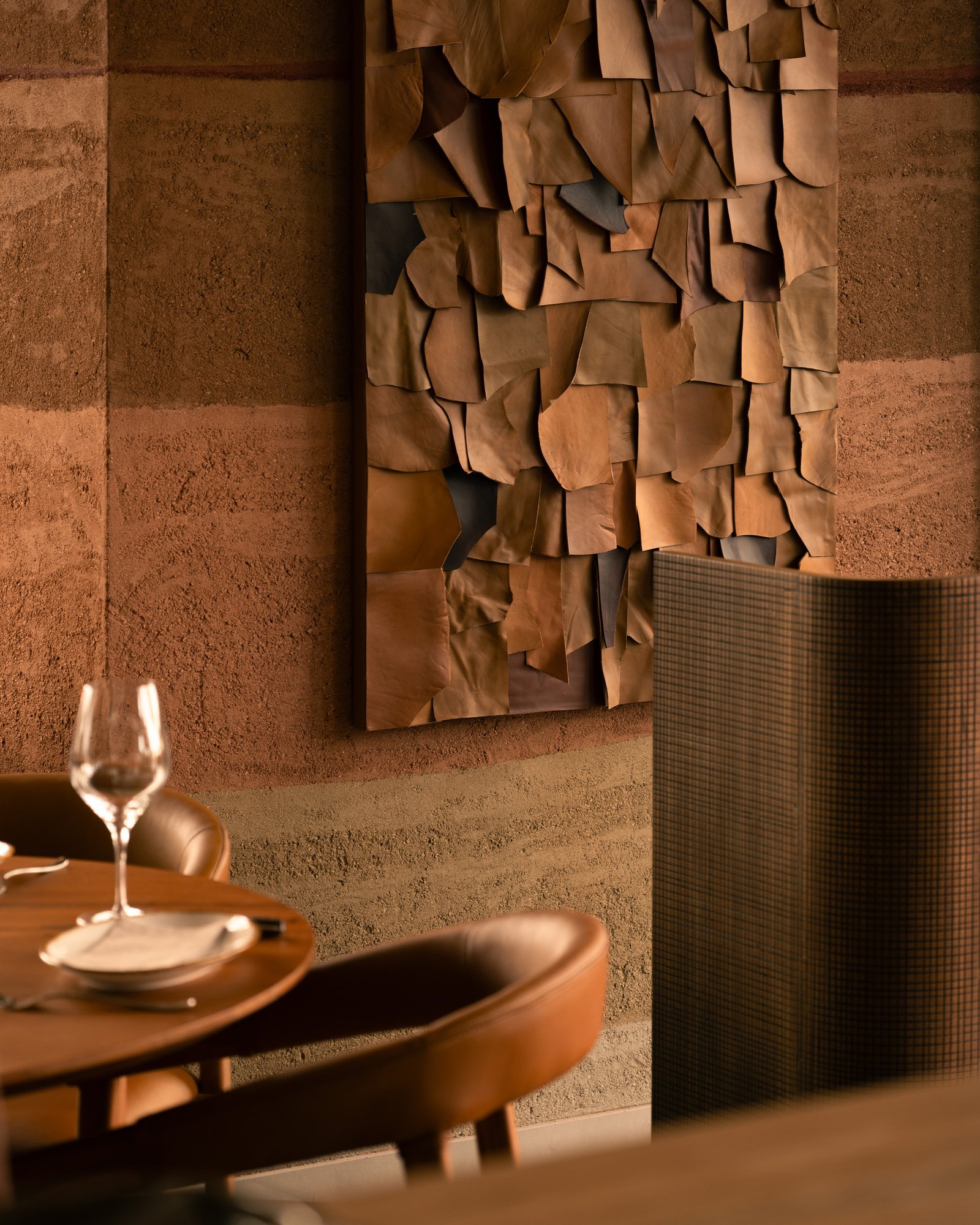 Custom rammed earth plaster in red-brown tones at Fireplace by Bedrock, Singapore.