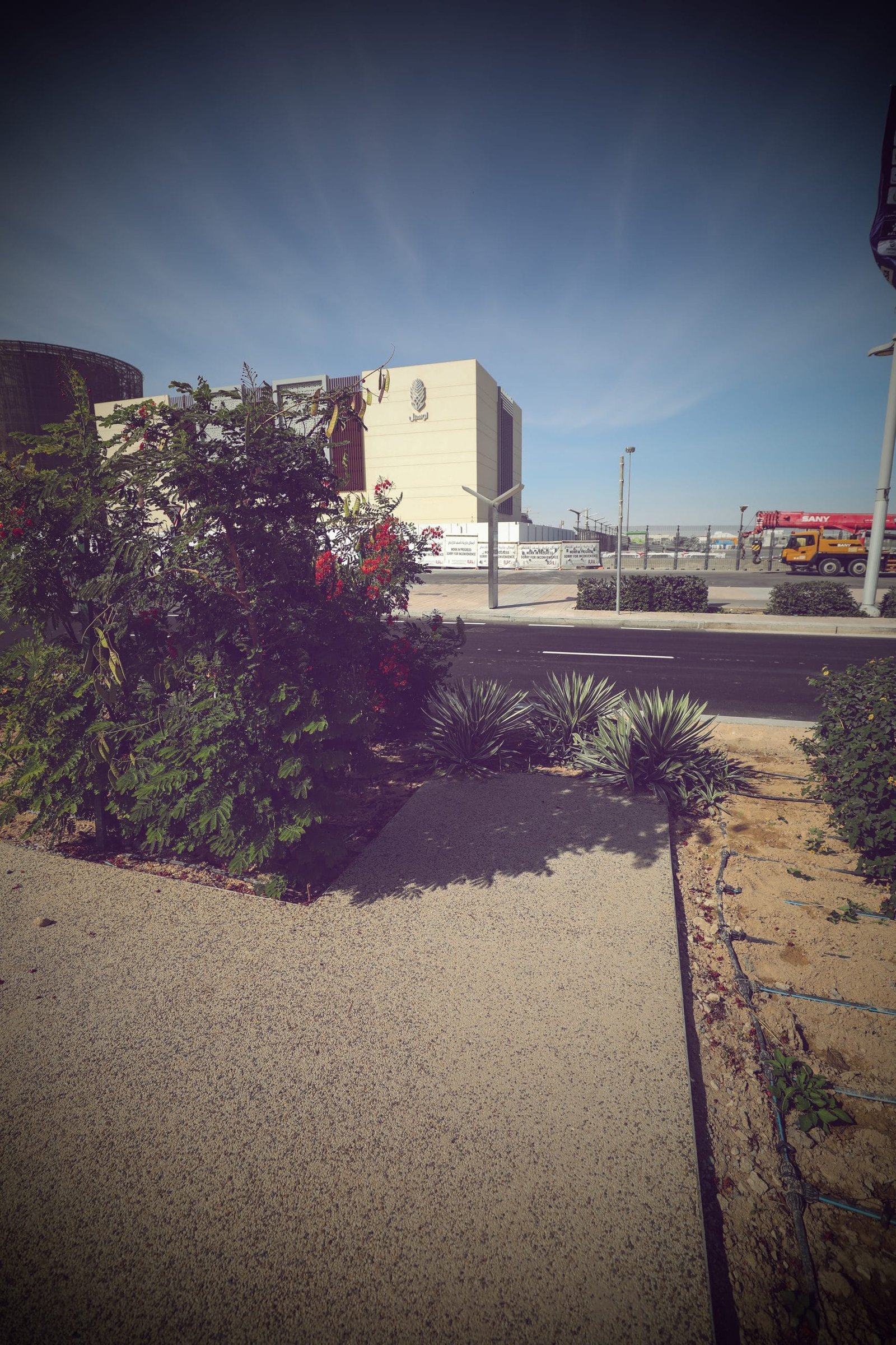 Resin bound aggregate path running beside planting beds on a landscaped promenade