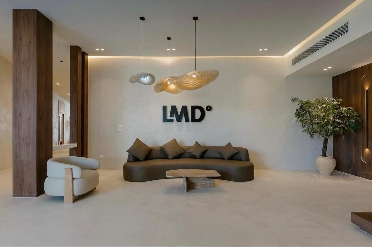 Sand-toned microcement through the sales centre lobby, LA7 Wellness Beach Club