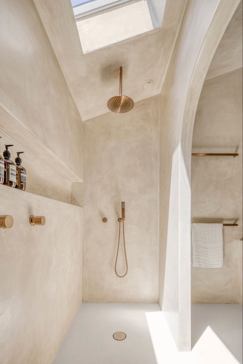 Microdur Plus microcement across the walls and floor of a shower room at Katara Hills LXR, Doha