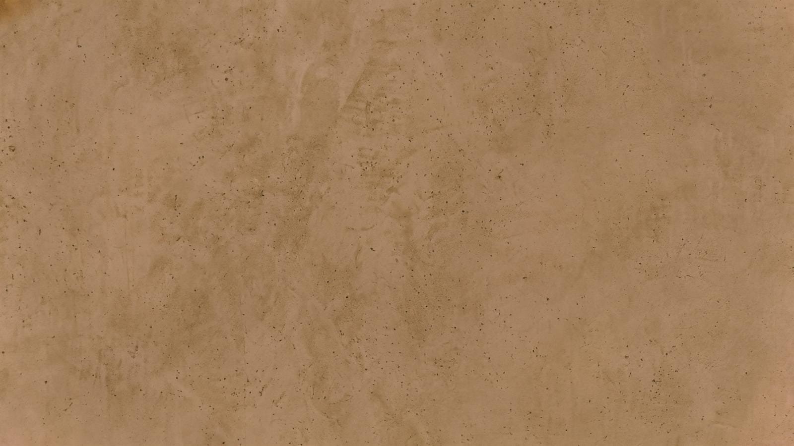 Close detail of hand-applied Microtadelakt lime plaster showing trowel movement and fine aggregate in a sand tone