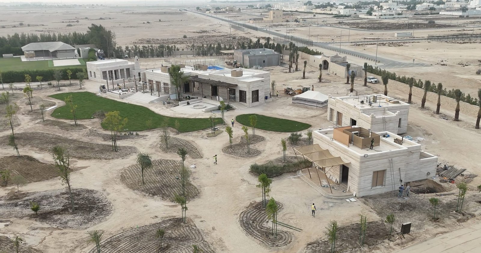 Aerial view of rammed earth buildings under construction at Al Kaaban Resort, Qatar