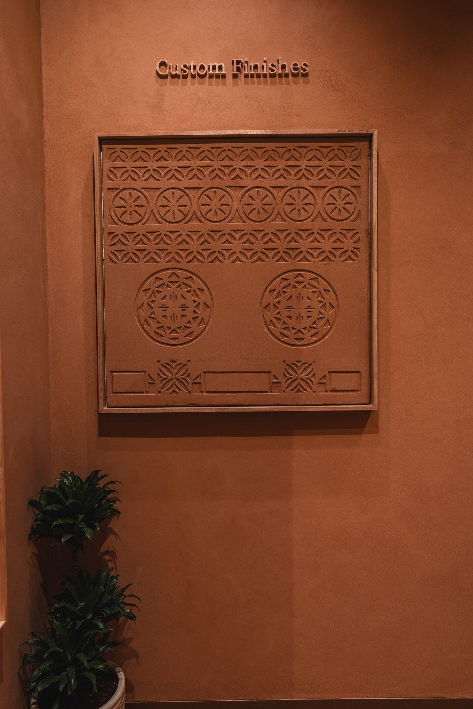 Terracotta clay plaster relief carved with Najdi geometric bands, Conmarble showroom