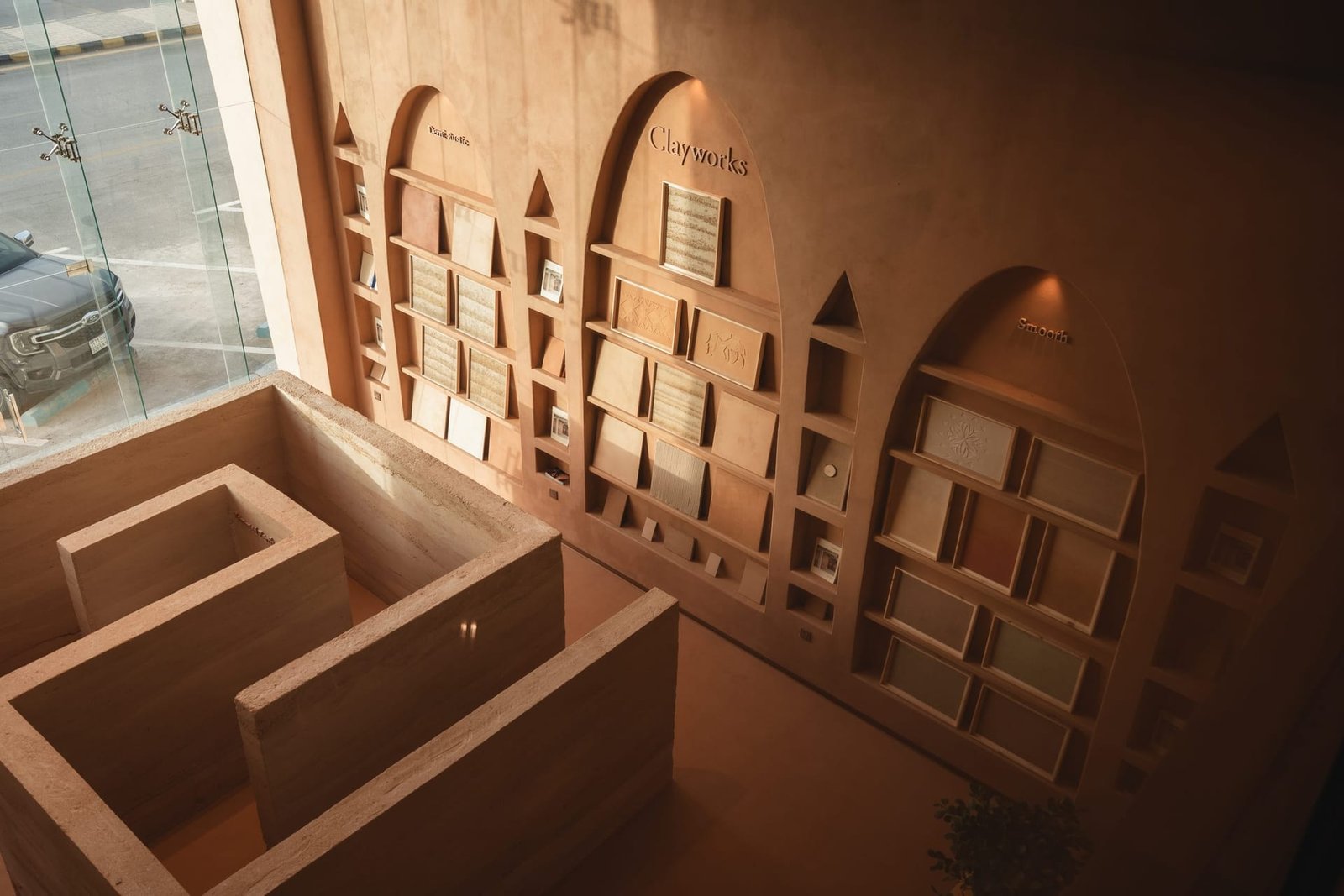 Rammed earth reception block and arched sample walls, Conmarble showroom, Riyadh